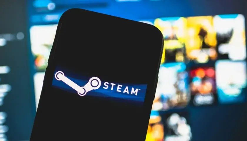Smartfon z logo Steam na tle gier. Chcesz wiedzieć, jak wyłączyć Big Picture Steam?