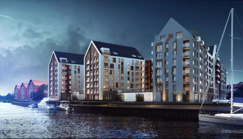 Nowoczesne apartamentowce nad wodą w Gdańsku, przy ulicy Chmielnej. Widok z rzeki na budynki i zacumowane jachty.