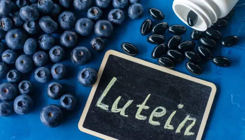 Jagody i kapsułki z luteiną na oczy. Luteina wspiera zdrowie wzroku, a jagody są jej naturalnym źródłem.