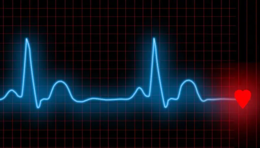 Niebieska linia EKG na czarnym tle z czerwoną siatką. Po prawej stronie widnieje czerwone serce, symbolizujące bicie serca i zdrowe HRV.