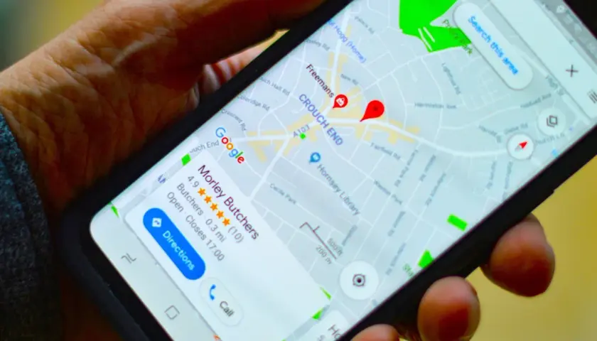 Na ekranie telefonu widoczna jest mapa Google z zaznaczoną pinezką Google w dzielnicy Crouch End. Wyświetla się też wizytówka "Morley Butchers".