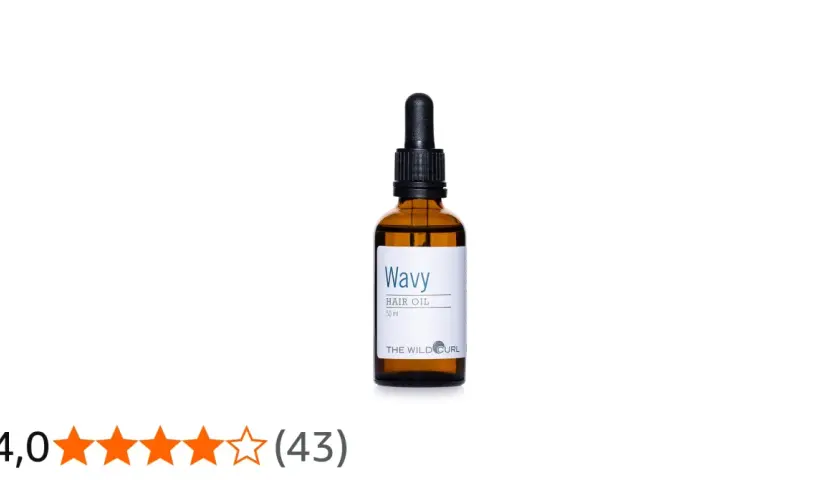 En flaska "Wavy Hair Oil" med pipett, perfekt för att ge näring och glans till torrt hår.