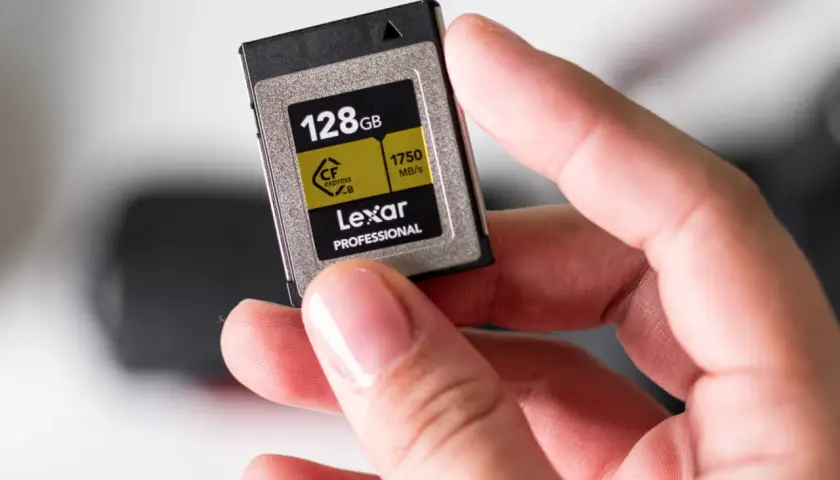 Dłoń trzyma kartę Lexar CFexpress B 128GB, jeden z zaawansowanych rodzajów kart pamięci dla profesjonalistów.