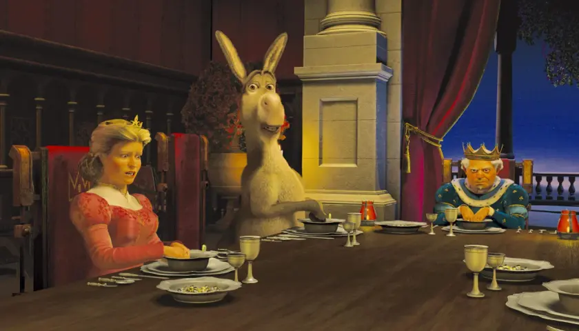 Królowa Fiona, Osioł i Król Harold przy stole. Scena z jednego z filmów DreamWorks.
