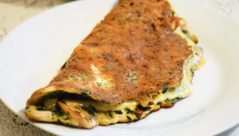 Złocisty omlet z serem i ziołami, idealny pomysł na to, co ugotować na kolację.