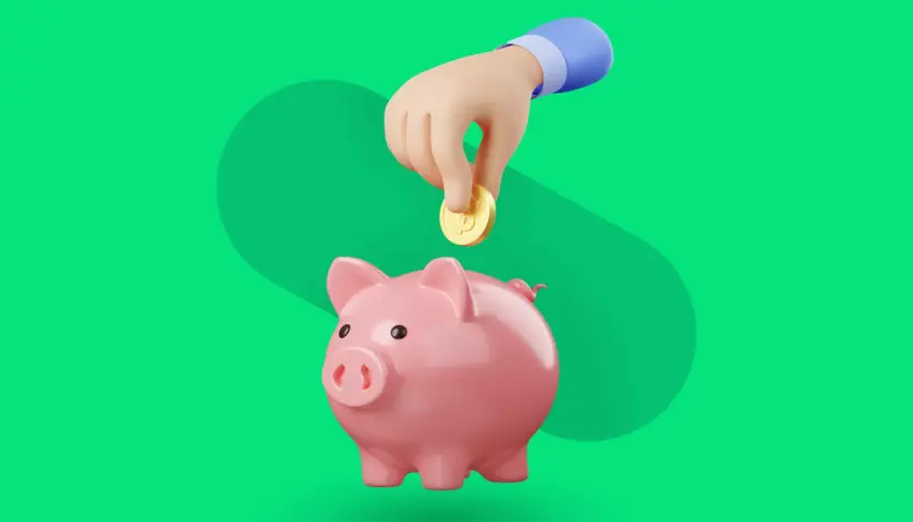 Różowa świnka skarbonka, do której ręka wrzuca monetę. Idealny symbol dla aplikacji do oszczędzania pieniędzy.