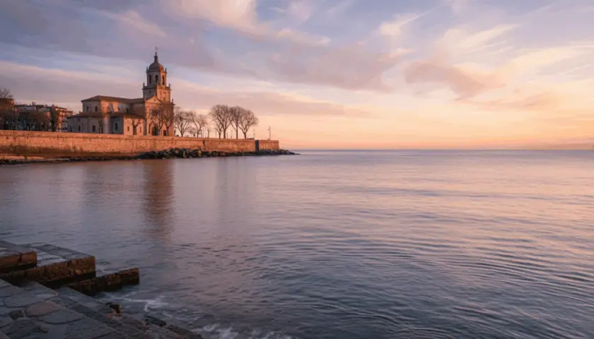 Edificio histórico junto al mar al amanecer, evocando poemas del mar.