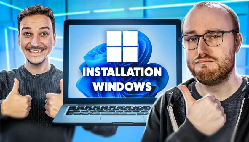 Deux hommes font un pouce levé devant un écran d'ordinateur affichant "INSTALLATION WINDOWS" et le logo Windows 11.