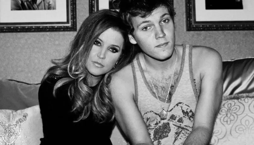 Lisa Marie Presley z synem Benjaminem Keough, siedzą blisko siebie na kanapie.