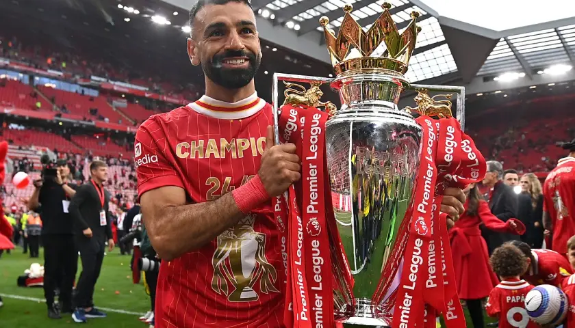 Piłkarz Liverpoolu, król strzelców Premier League, z pucharem mistrzowskim.