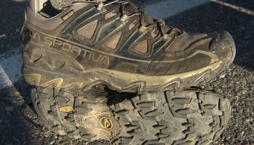 A muddy La Sportiva hiking shoe with "GORE-TEX" branding, indicating its waterproof and breathable meaning for shoes.