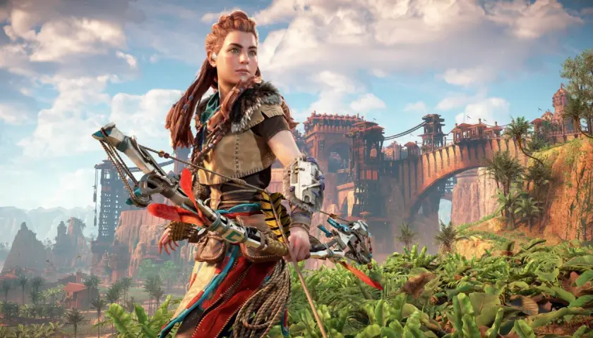 Aloy z łukiem w dłoni, gotowa do walki w świecie Horizon Zero Dawn Remastered. W tle widać imponujący most i ruiny starożytnej cywilizacji.