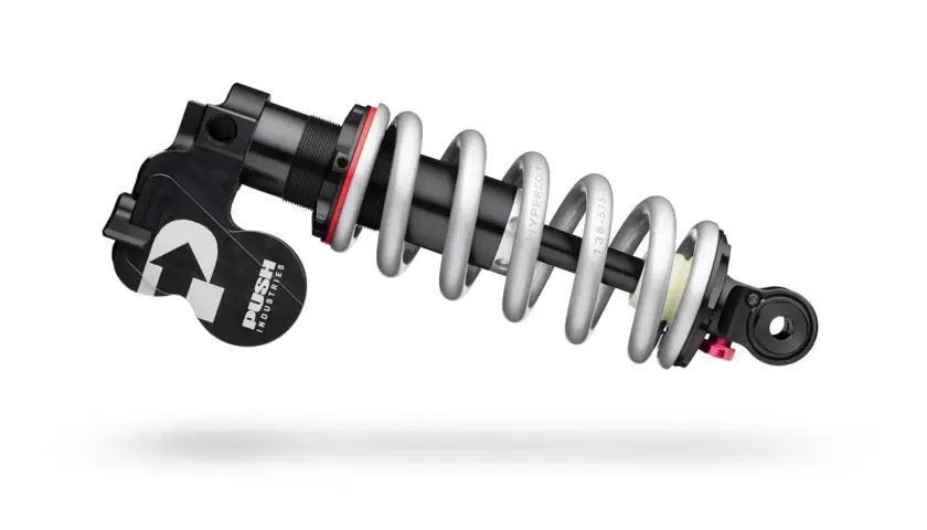 A PUSH Industries 11-6 rear shock absorber with a silver coil spring and black body, ready to tackle any trail.