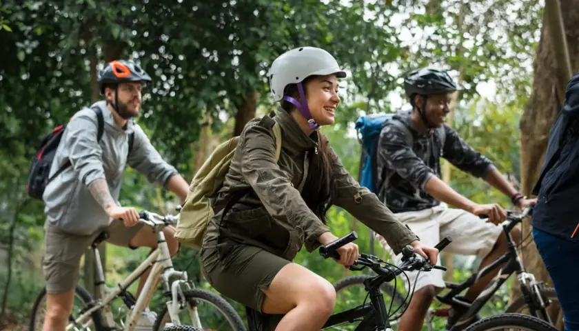 Friends enjoying a scenic ride through the woods, a perfect scene for France bicycle tours.
