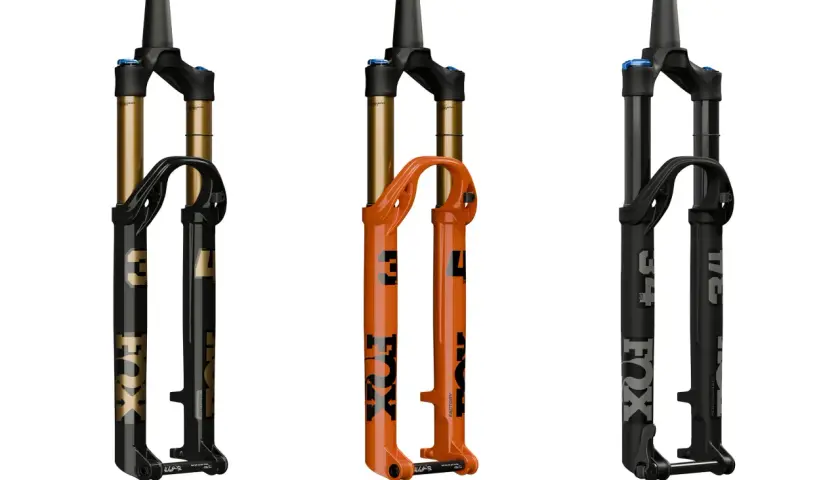 Three Fox Float SL suspension forks: one black with gold accents, one bright orange, and one matte black. Ready to float over any terrain.