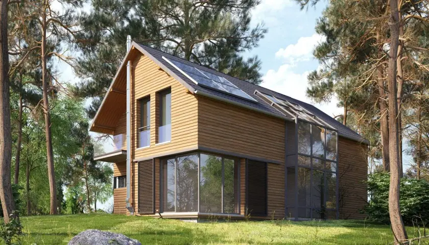 Maison en bois avec panneaux solaires sur le toit, un exemple parfait pour rendre sa maison écologique.