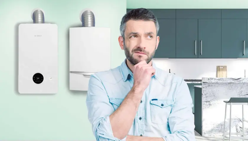 Uomo pensieroso davanti a due caldaie, una delle quali è una caldaia turbo Bosch.