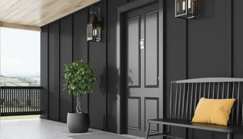 Elegancka, ciemna elewacja domu z nowoczesnymi lampami i stylową ławką.