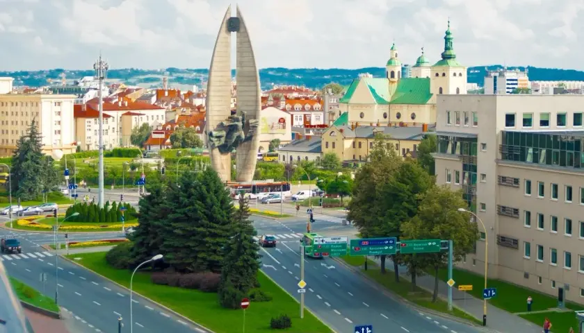 Widok na pomnik, kościół i ruchliwe skrzyżowanie w Lublinie.