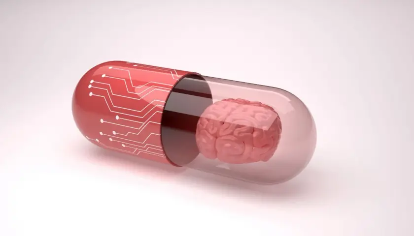 Czerwona kapsułka z obwodami drukowanymi zawiera mózg. Symbolizuje to potencjalne leki, takie jak inhibitory MAO, które wpływają na funkcje mózgu.
