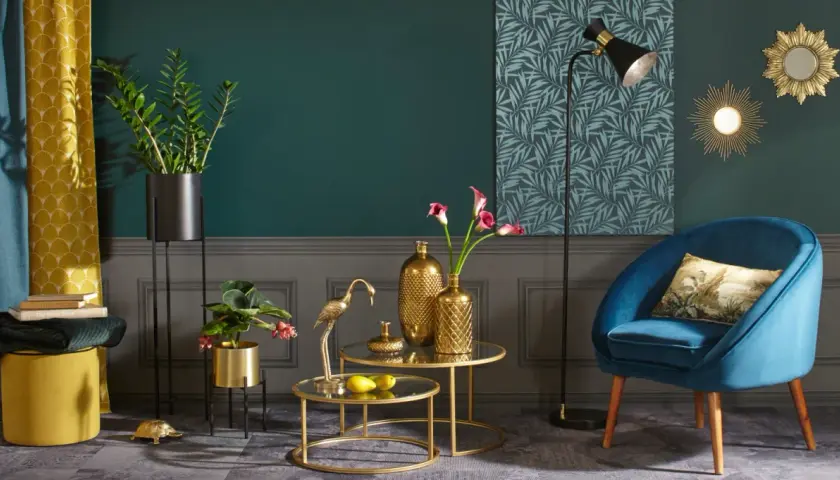 Elegancki salon z turkusowym fotelem i złotymi akcentami. Co to znaczy golden? To blask wazonów, figurki żurawia i ozdobnych luster.