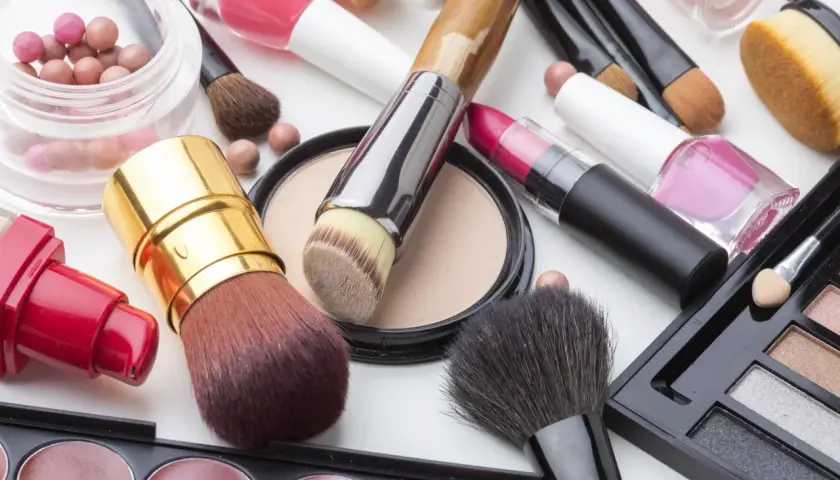 Pinceaux, rouges à lèvres, vernis et poudres pour un maquillage simple et chic.