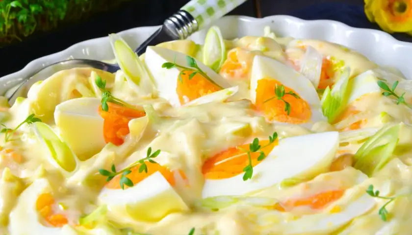 Cremiger Eiersalat mit Karottenstückchen und Frühlingszwiebeln, garniert mit Kresse. Ein köstlicher Salat, der an 7 Tassen Salat erinnert.
