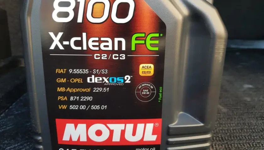 Czarna butelka oleju silnikowego Motul 8100 X-clean FE 5W30 z widocznymi specyfikacjami.