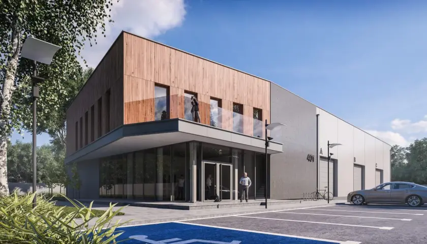 Nowoczesne projekty magazynów z drewnianą elewacją i betonem. Przed budynkiem parking z miejscem dla niepełnosprawnych i samochodem.