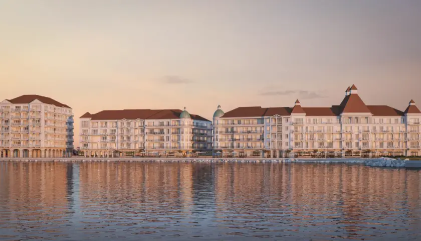 Eleganckie budynki nad wodą, z tarasami i dachami w kolorze cegły. To wizualizacja mariny royale darłowo, idealnego miejsca na wypoczynek.