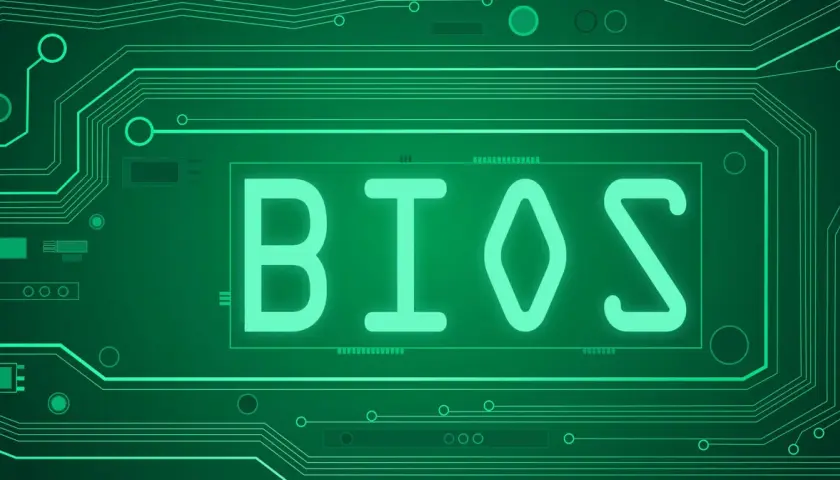 Zielony obwód drukowany z napisem BIOS. Dowiedz się, jak zaktualizować BIOS, aby Twój komputer działał sprawniej.