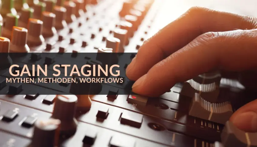 Hand an einem Mischpult, das die Bedeutung von Gain Staging für Mythen, Methoden und Workflows hervorhebt.