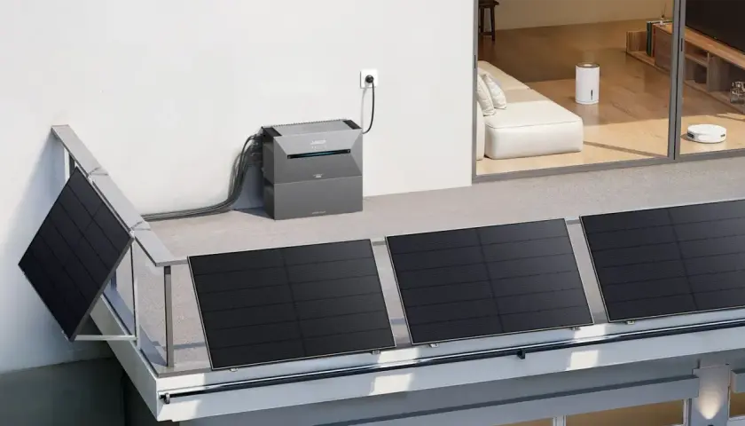 Balkonkraftwerk mit Speicher sinnvoll: Solarmodule auf dem Balkongeländer, verbunden mit einem grauem Speichergerät, das in die Steckdose gesteckt ist.