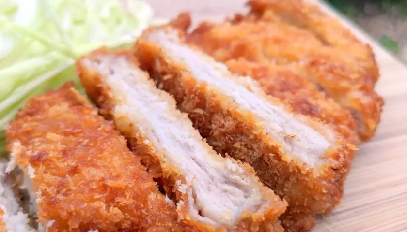 Juicy, baked tonkatsu, sliced and served with shredded cabbage. A delicious and crispy meal.