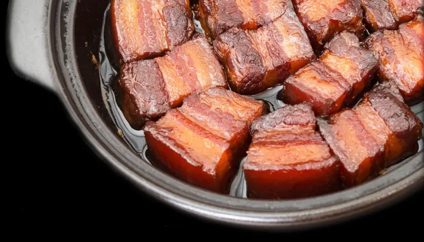 Close-up of succulent pork belly cubes, glistening in a rich sauce, ready for a delicious miso pork belly recipe.