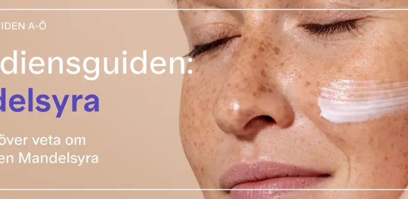 En närbild på en kvinna med fräknar som applicerar kräm. Texten lyder "Ingrediensguiden: Mandelsyra. Allt du behöver veta om ingrediensen Mandelsyra.