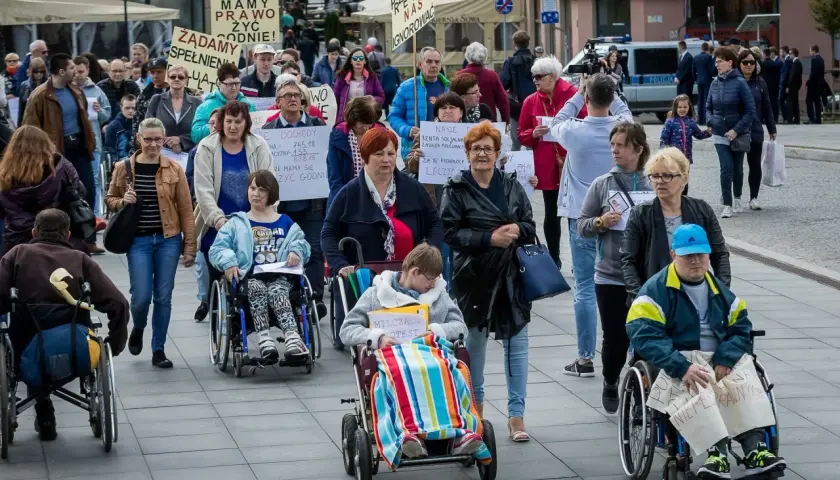 Protest osób na wózkach inwalidzkich. Pytanie: czy dodatek pielęgnacyjny wlicza się do 500 plus dla niepełnosprawnych?