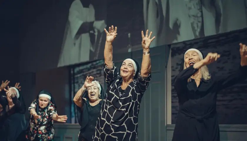 Radosne seniorki w habicie tańczą na scenie. Sprawdź repertuar Teatru Łaźnia Nowa!