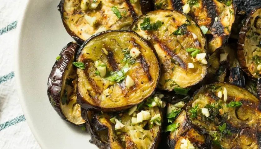Aubergines grillées au four, garnies d'ail et de persil frais. Une recette simple et savoureuse pour sublimer ce légume.