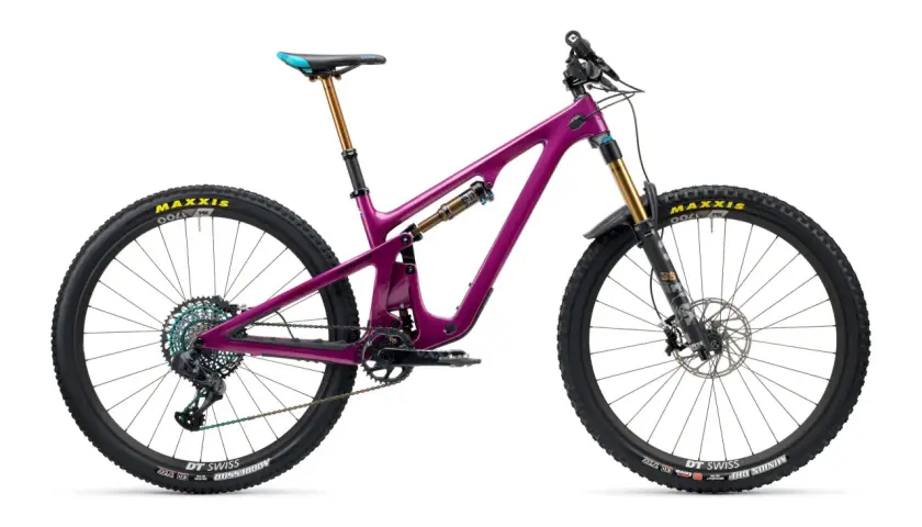 A vibrant purple Yeti SB140 mountain bike, ready for adventure, with gold suspension and colorful drivetrain.