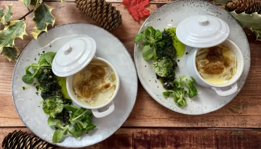 Deux gratins de cardons servis avec des escargots persillade et une salade verte. Parfait pour savoir que manger avec un gratin de cardons.