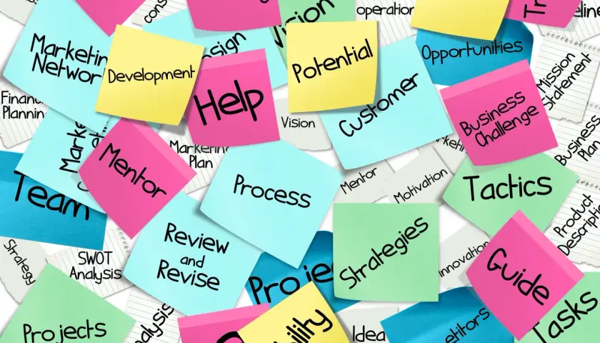 Sticky notes with business terms like "Strategy," "Team," and "Development" offer good survey comments examples for project feedback.