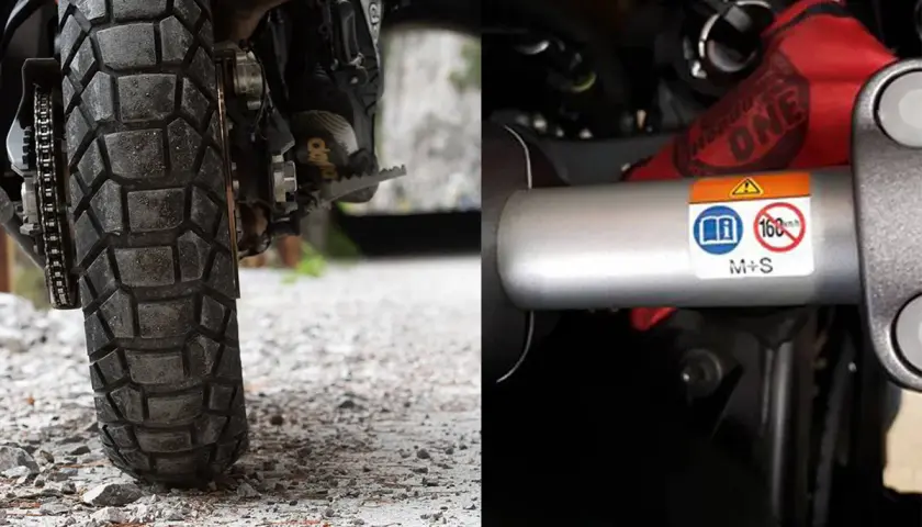 Neumático de moto con banda de rodadura agresiva y etiqueta que indica "M+S", aclarando que significa "Mud and Snow" (barro y nieve) en neumáticos.