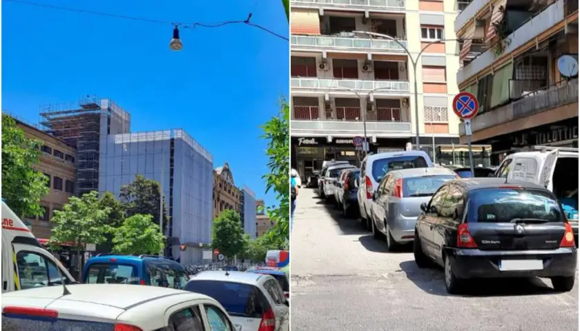 Parcheggio scambiatore Roma: auto in fila su strada urbana con edifici residenziali e un cantiere.