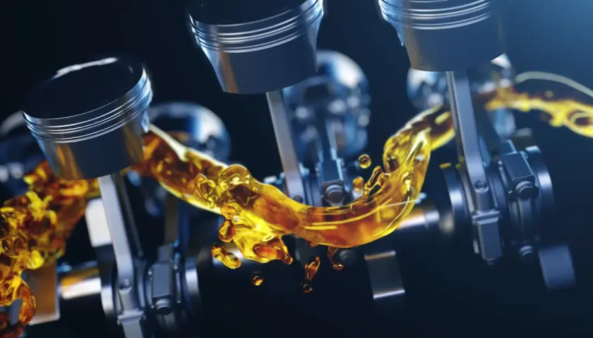 Pistones de motor con aceite dorado fluyendo. Un nivel aceite coche alto es crucial para la lubricación.