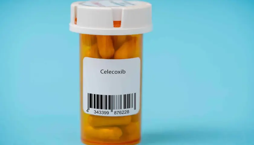 Orange pill bottle with a label reading "Celecoxib" and a barcode.