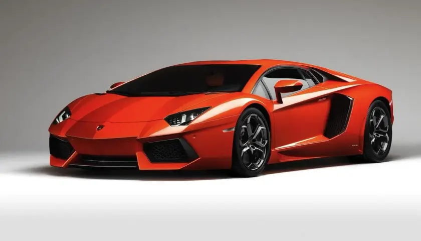 Pomarańczowy Lamborghini Aventador, bez wątpienia najładniejsze auto na świecie, prezentuje swoje ostre linie i agresywną sylwetkę.