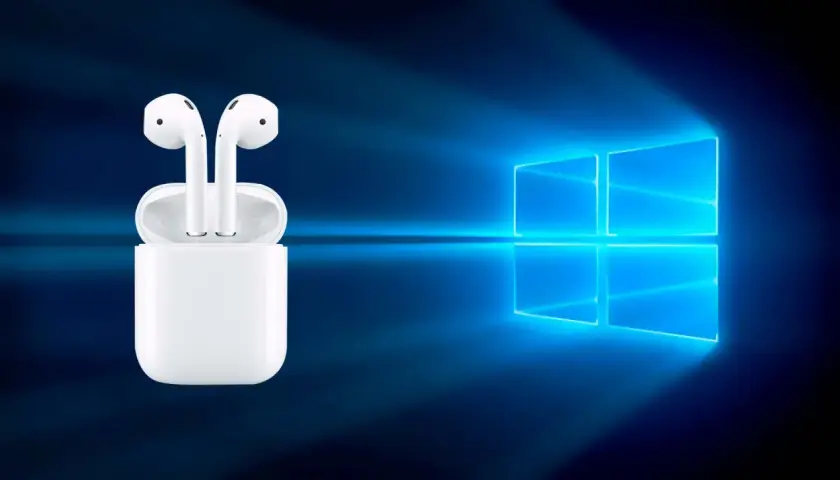 AirPods w etui na tle logo Windows. Czy da się podłączyć AirPods do laptopa? Tak, to możliwe!