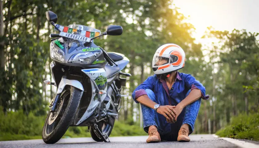 Giovane con casco da moto, pronto per allargare un casco stretto e partire per un'avventura.