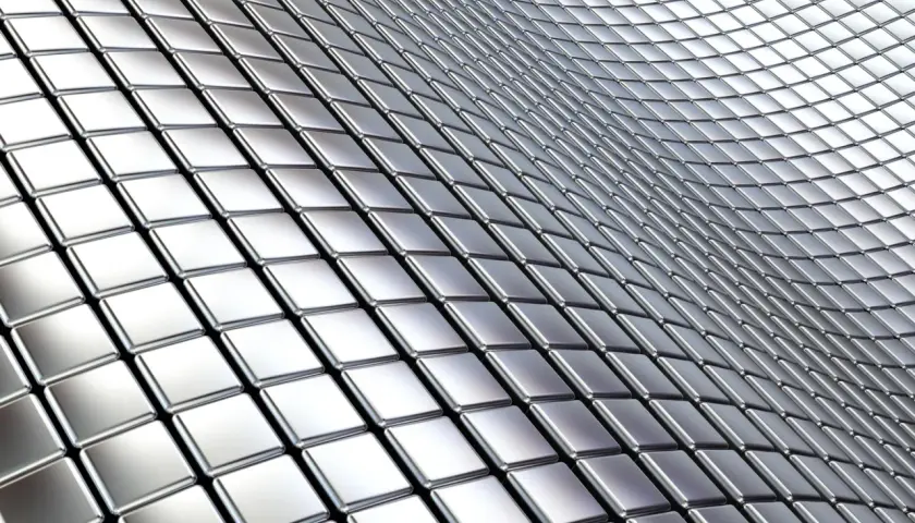 Metaliczne kwadraty tworzą falistą powierzchnię, przypominającą tabelę gatunków stali nierdzewnej.